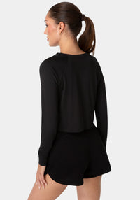 Back View-BEBE SPORT LONG SLEEVE LASER CUT TOP-BLACK / IRIDESCENT