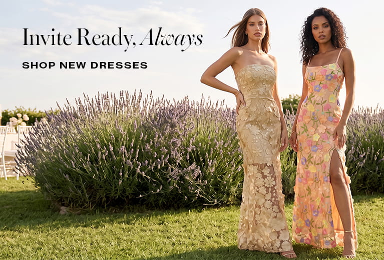 Two women wearing elegant floral and lace dresses standing in a lavender field; text reads "Invite Ready, Always - Shop New Dresses" by bebe.